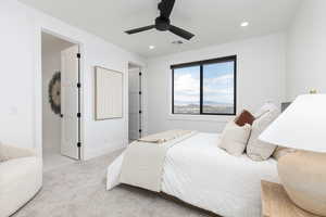 Carpeted bedroom featuring a ceiling fan and recessed lighting