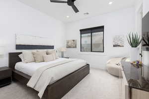 Carpeted bedroom featuring a ceiling fan and recessed lighting