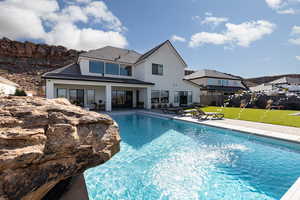 Rear view of property with a patio, stucco siding, and a tile roof
