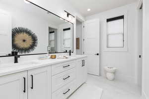 Full bath featuring double vanity and recessed lighting
