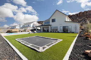 Back of property with a patio area and stucco siding