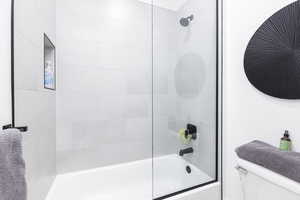 Full bath featuring bathing tub / shower combination and toilet