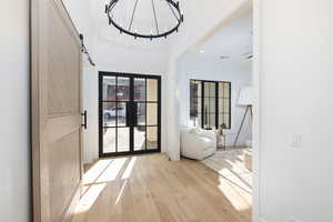Doorway to outside with a barn door, hardwood / wood-style flooring, and recessed lighting