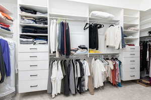 Walk in closet with light carpet