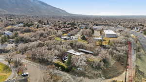 Aerial view of property and surrounding area featuring mountains