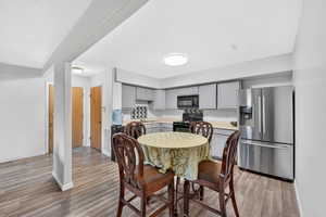 Dining area with baseboards and light wood-style flooring