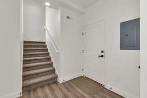 Foyer entrance with electric panel and wood finished floors