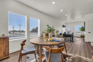 Dining space featuring wood finished floors and recessed lighting