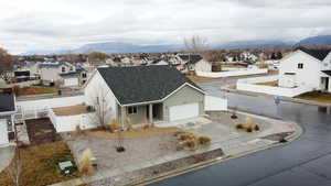 View of front facade featuring a residential view, driveway, an attached garage, covered porch, and a mountain view
