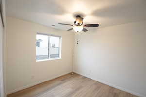 Spare room featuring light wood finished floors and a ceiling fan