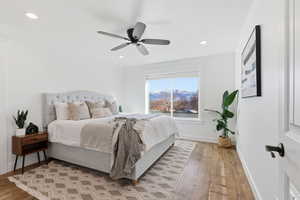 Bedroom featuring light wood-type flooring, ceiling fan, and recessed lighting