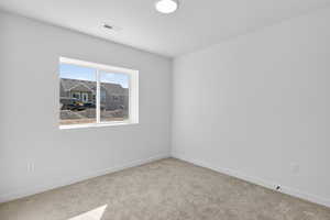 Carpeted empty room with baseboards