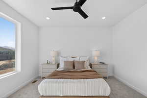 Bedroom with ceiling fan, light carpet, and recessed lighting