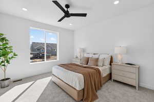 Bedroom with light colored carpet, a ceiling fan, and recessed lighting
