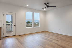 Empty room with ceiling fan, recessed lighting, and light wood finished floors