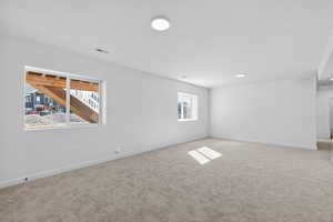 Basement with baseboards and carpet flooring