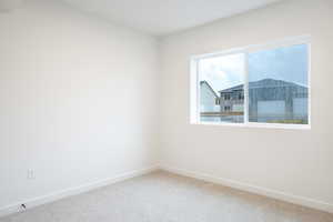 Unfurnished room with baseboards and carpet floors