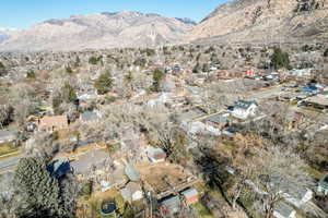 Aerial overview of property's location featuring nearby suburban area and a mountainous background