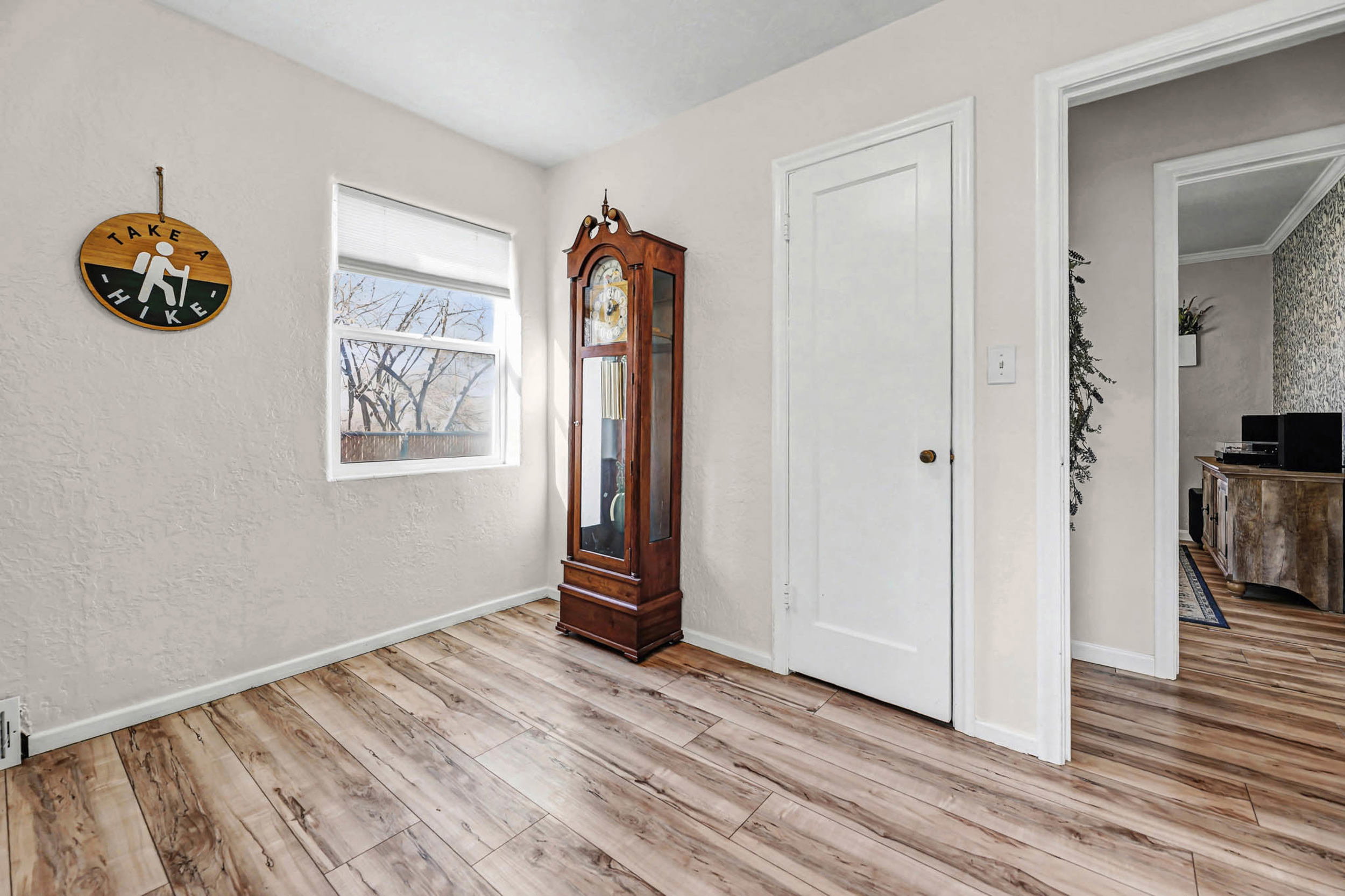 Unfurnished bedroom with light wood-style floors and a textured wall