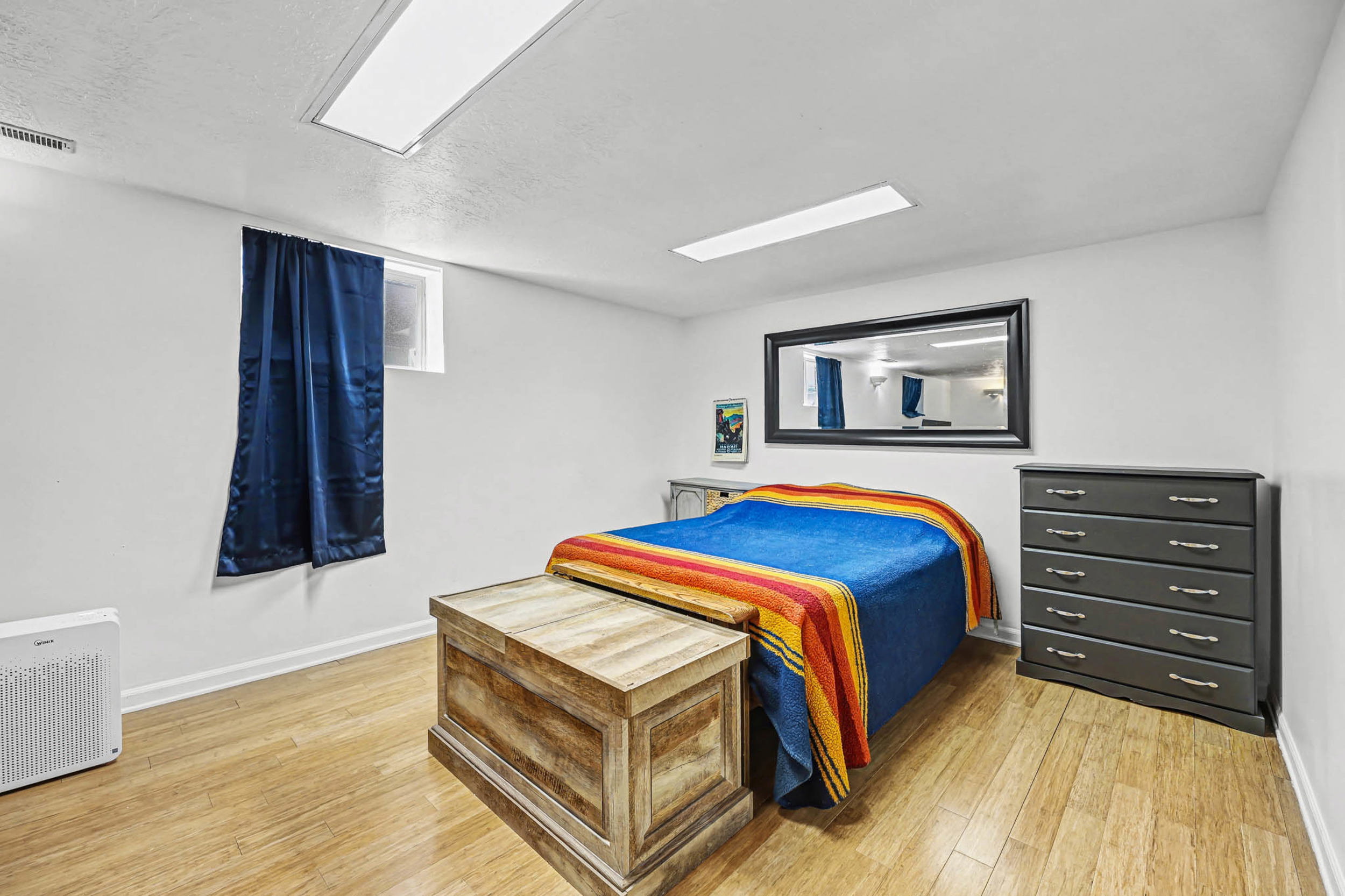 Bedroom with light wood-style floors and a textured ceiling