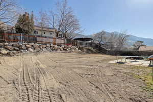 Fenced backyard featuring a patio and a mountain view