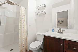 Full bath with a shower stall and vanity