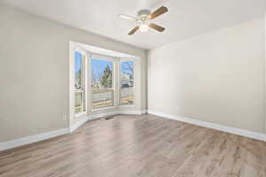 Unfurnished room with light wood-style floors and ceiling fan