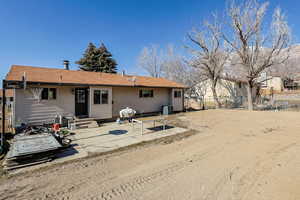 Rear view of property featuring a patio area and entry steps