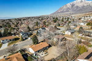 Aerial view of property's location featuring a mountain backdrop and nearby suburban area