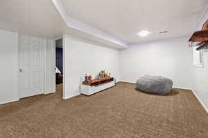 Interior space featuring a textured ceiling and carpet flooring