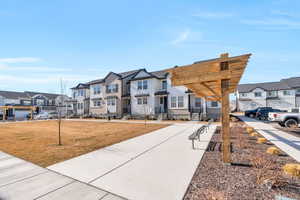 View of front of property featuring a residential view and a front lawn