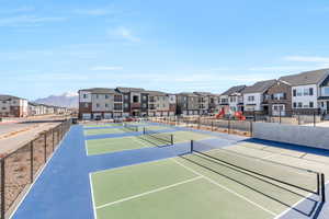 View of tennis court featuring a residential view