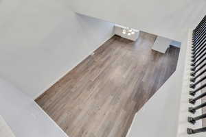 Stairway with wood finished floors and baseboards