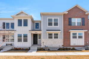 View of front of property with board and batten siding and stone siding