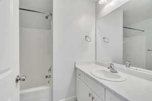 Full bath featuring shower / washtub combination and vanity