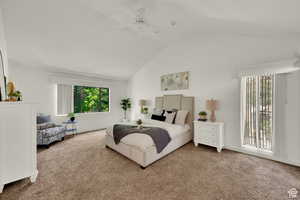 Carpeted bedroom with a ceiling fan and a high ceiling