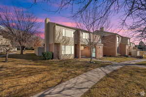 View of front of property with a chimney and a front yard