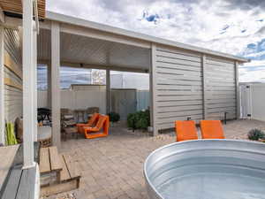 Fenced backyard featuring a patio and a gate