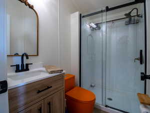 Full bathroom with a stall shower, vanity, and a textured ceiling