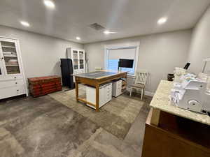 Office with concrete floors and recessed lighting