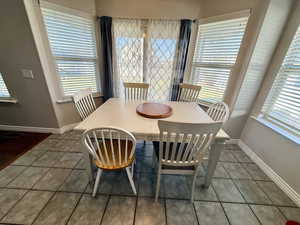 Dining area featuring dark tile patterned floors
