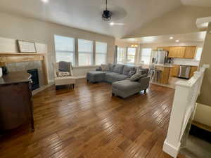 Living room with a fireplace, recessed lighting, light wood-style flooring, plenty of natural light, and lofted ceiling