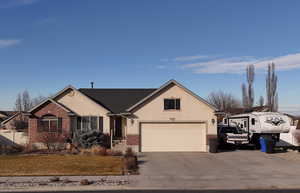 View of front of property featuring stucco siding and brick siding