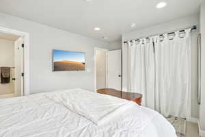 Bedroom with recessed lighting and baseboards
