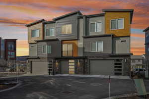 Modern home with a garage and stone siding