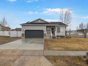 Ranch-style house featuring concrete driveway, brick siding, and an attached garage