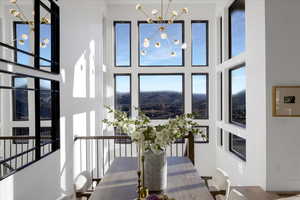 Dining area featuring hanging lights, a high ceiling, and healthy amount of natural light