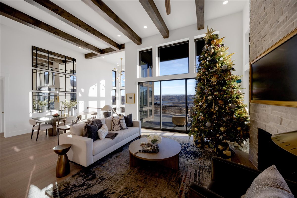 Living room featuring healthy amount of natural light, wood finished floors, a stone fireplace, and recessed lighting