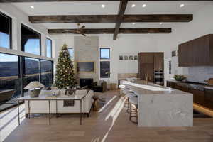 Living room featuring recessed lighting, light wood-type flooring, a large fireplace, and ceiling fan