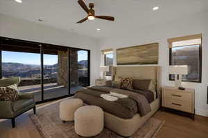 Bedroom featuring a mountain view, access to exterior, wood finished floors, ceiling fan, and recessed lighting